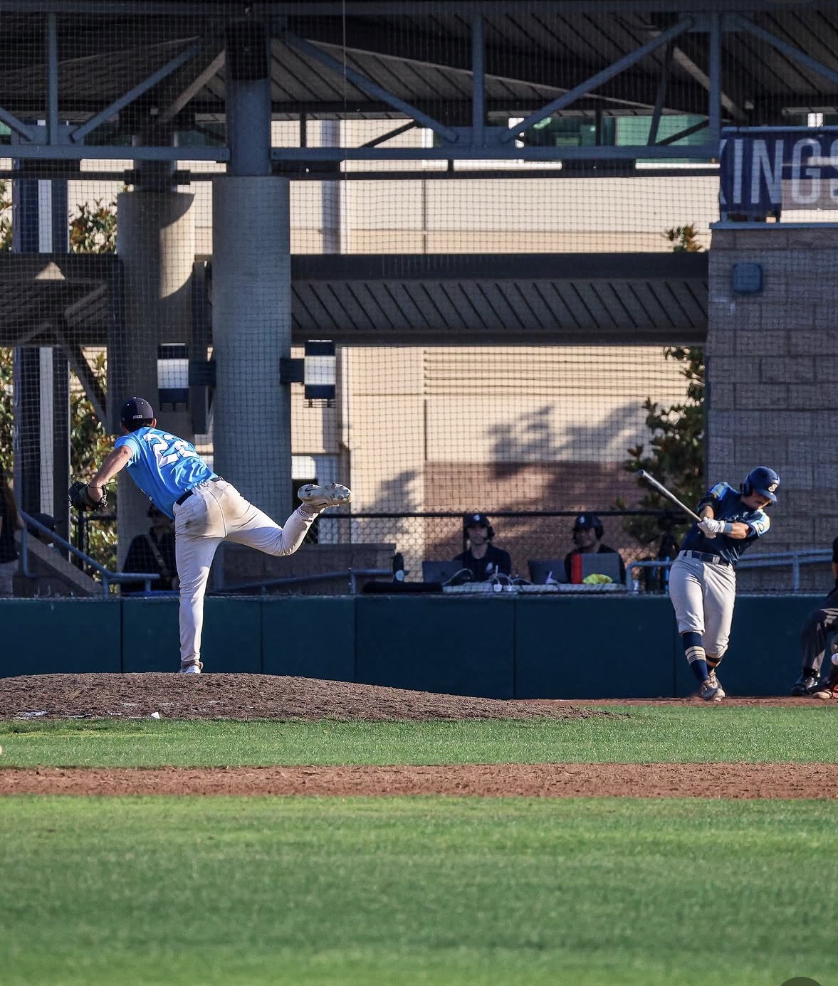 Pitcher measuring velocity during a lesson